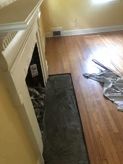 Hardwood floor opened beside a fireplace during drying